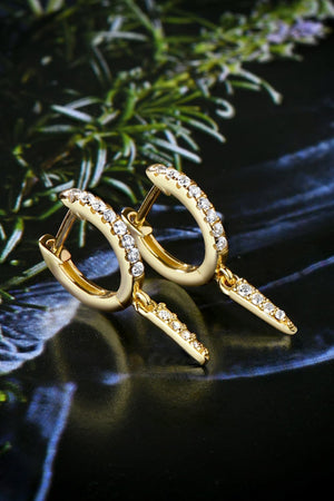 Gold pavé spike huggie earrings with dangling spike charms.