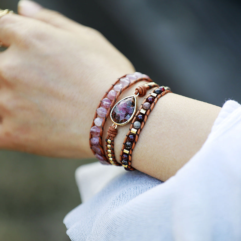 Bohemian wrap bracelet with gemstone detail, featuring pink and burgundy beads on leather.