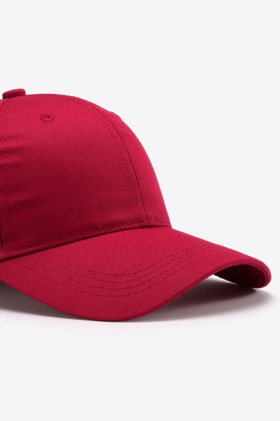Red cotton twill baseball cap with curved brim and stitched details.