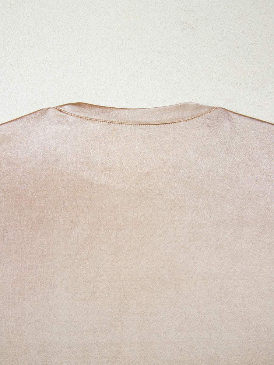 Sleeveless champagne tank top with a lustrous metallic finish and crew neckline.