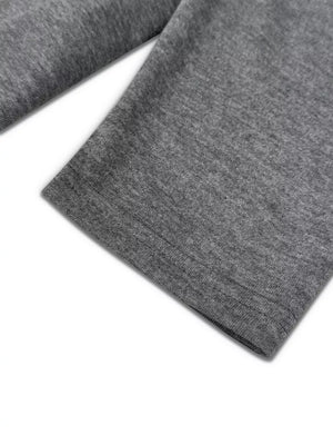 Dark gray crew neck pajama set detail showing hem stitching on soft fabric.