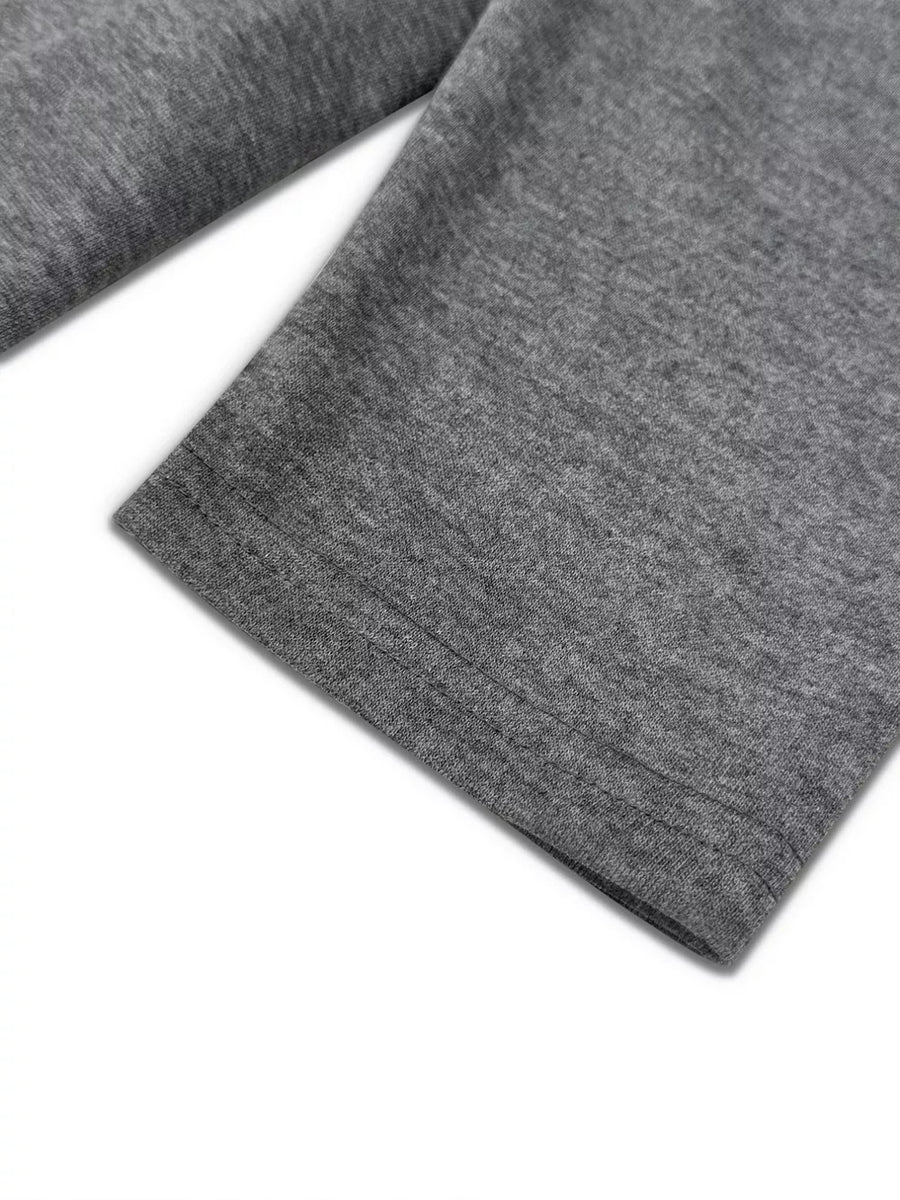 Dark gray crew neck pajama set detail showing hem stitching on soft fabric.