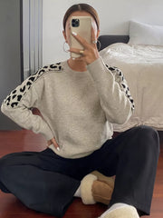 black pullover sweater featuring ribbed and leopard