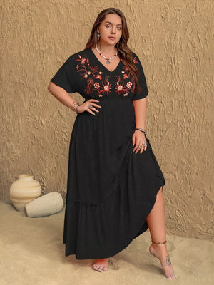 Black plus size maxi dress with V-neck and floral embroidery, ruffled hem