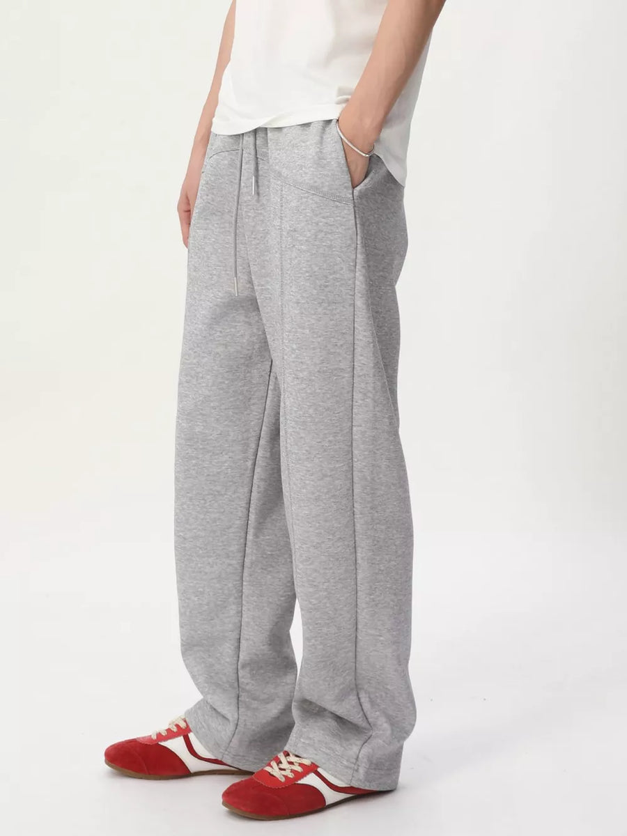Gray cotton drawstring sweatpants with wide legs and a relaxed fit.