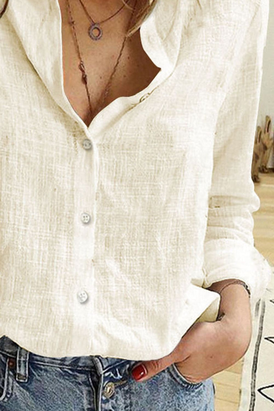 Ivory linen button-down relaxed fit blouse with textured fabric and button details.