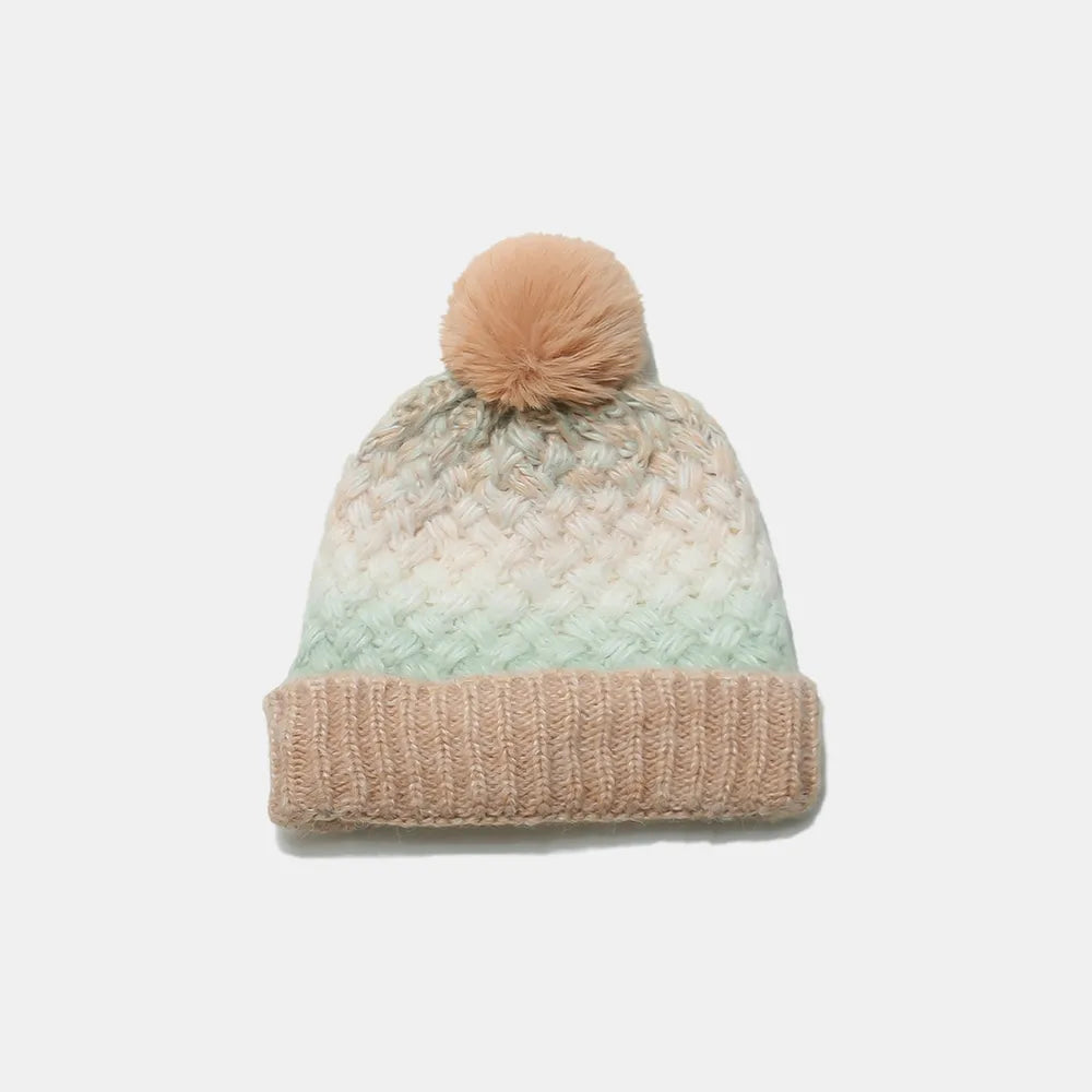 Textured ombre knit pom beanie in camel and pastel blue with a ribbed cuff.
