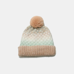 Textured ombre knit pom beanie in camel and pastel blue with a ribbed cuff.