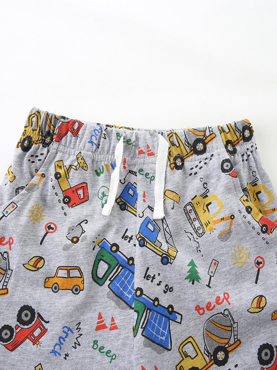 Toddler grey shorts with playful construction vehicle print and white drawstring waist.