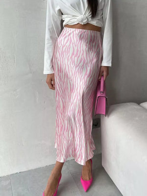 Satin midi skirt with pink and white zebra print, high waist, and bias cut.