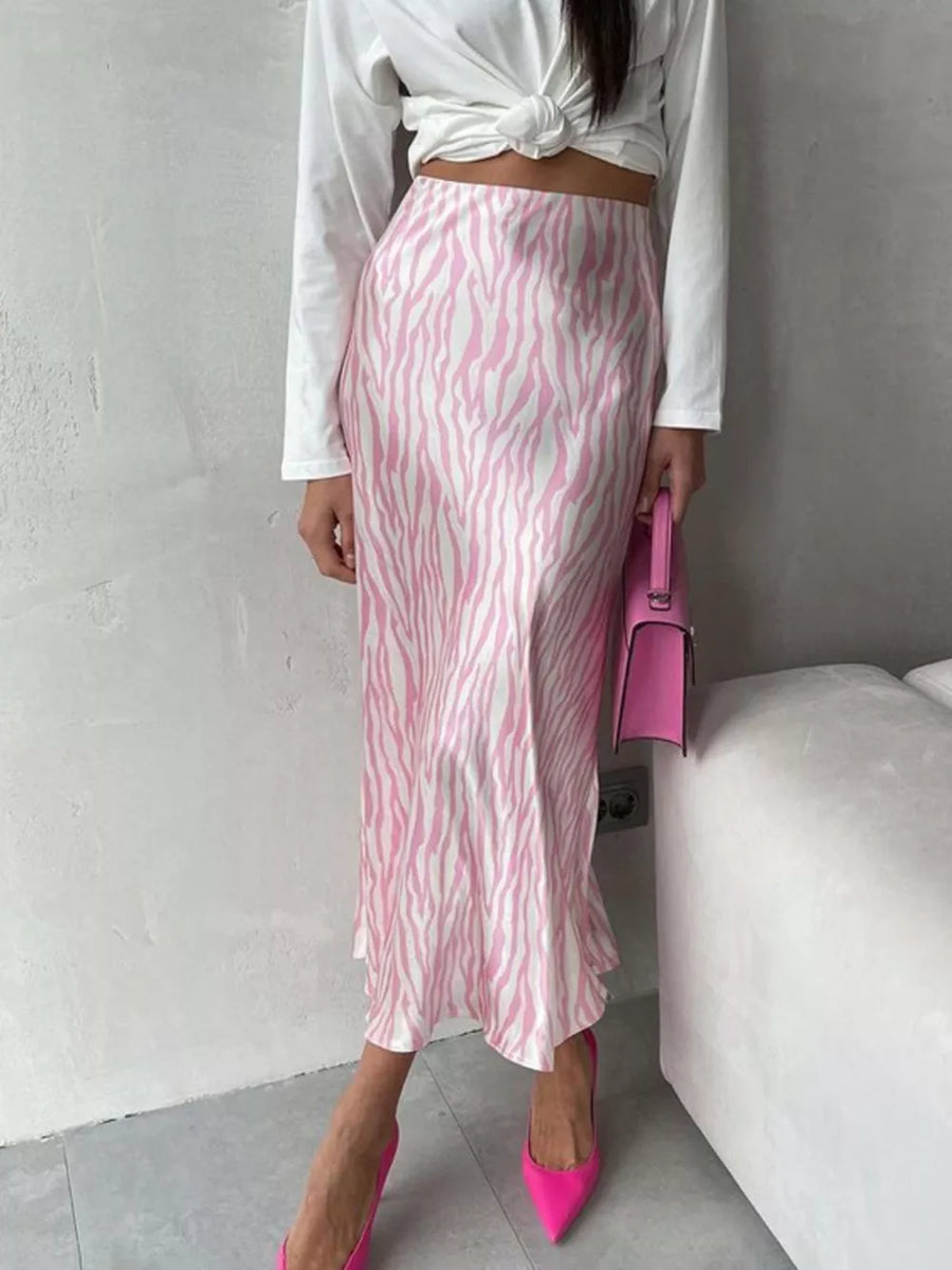Satin midi skirt with pink and white zebra print, high waist, and bias cut.