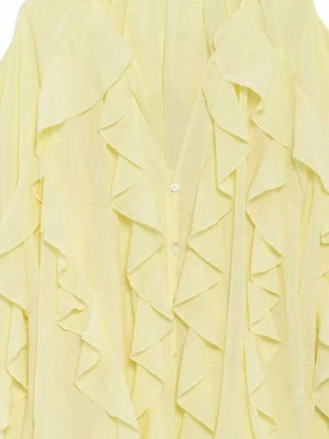 Yellow sheer long-sleeve blouse with cascading ruffles and button front detail.