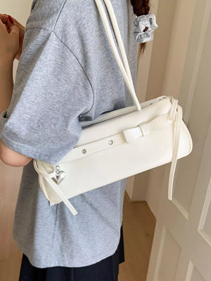 White PU leather shoulder bag with silver heart charm and bow detail