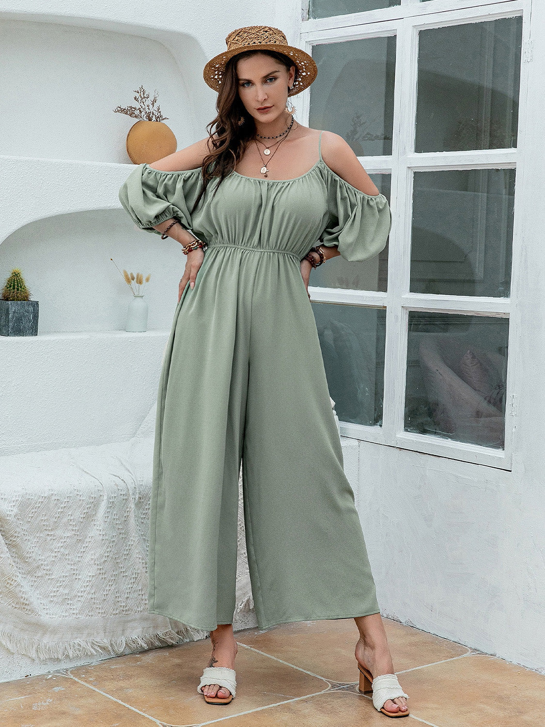 Sage off-shoulder jumpsuit with gathered waist and wide legs, 100% polyester.