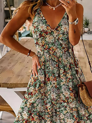 Floral tiered maxi dress with spaghetti straps in Black Forest, featuring a V-neck and flowy skirt.
