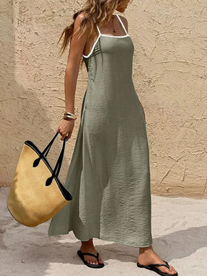 Olive spaghetti strap maxi dress with white contrasting trim and a-line cut.