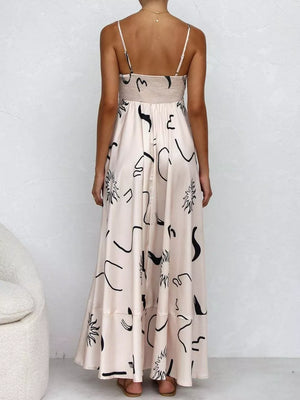 Blush pink maxi dress with abstract black print, spaghetti straps, and smocked bodice.