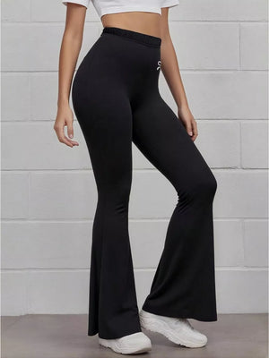 Black flared high-waist active pants with white bow emblem detail.