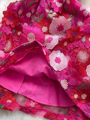 Embroidered floral mini dress in vibrant pink with layered mesh and applique flowers.