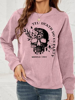 Dusty pink corduroy sweatshirt with a black floral skull graphic and text.