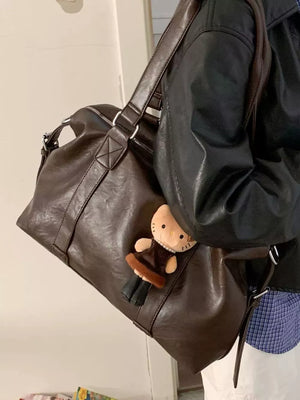 Brown pu leather shoulder bag with a cute Hello Kitty charm.
