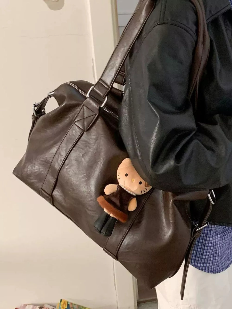 Brown pu leather shoulder bag with a cute Hello Kitty charm.