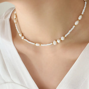 White pearl and seed bead strand necklace with gold accents