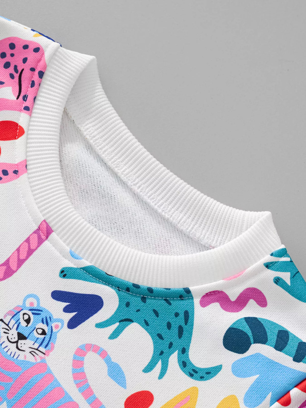 Kids crew neck sweatshirt in multicolor with a playful animal print pattern.