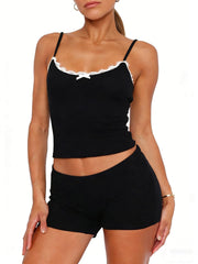Black lace-trimmed cami and shorts set with a white bow detail.
