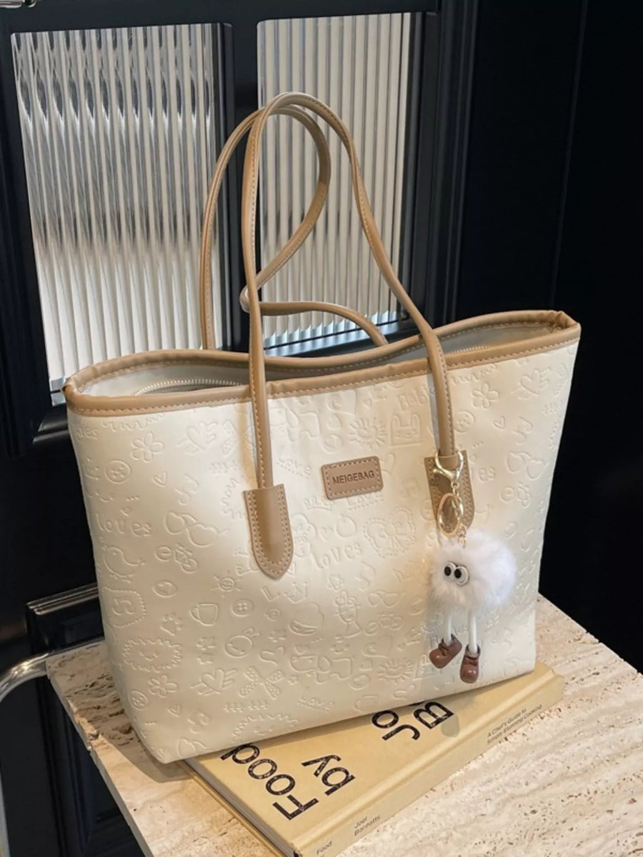 Embossed PU leather tote bag in Khakis with a fluffy charm and tan trim.