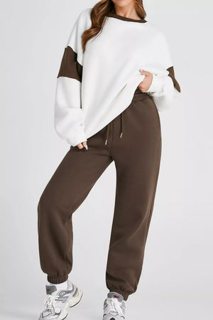 Oversized white sweatshirt with chocolate color-block sleeves and matching chocolate sweatpants.