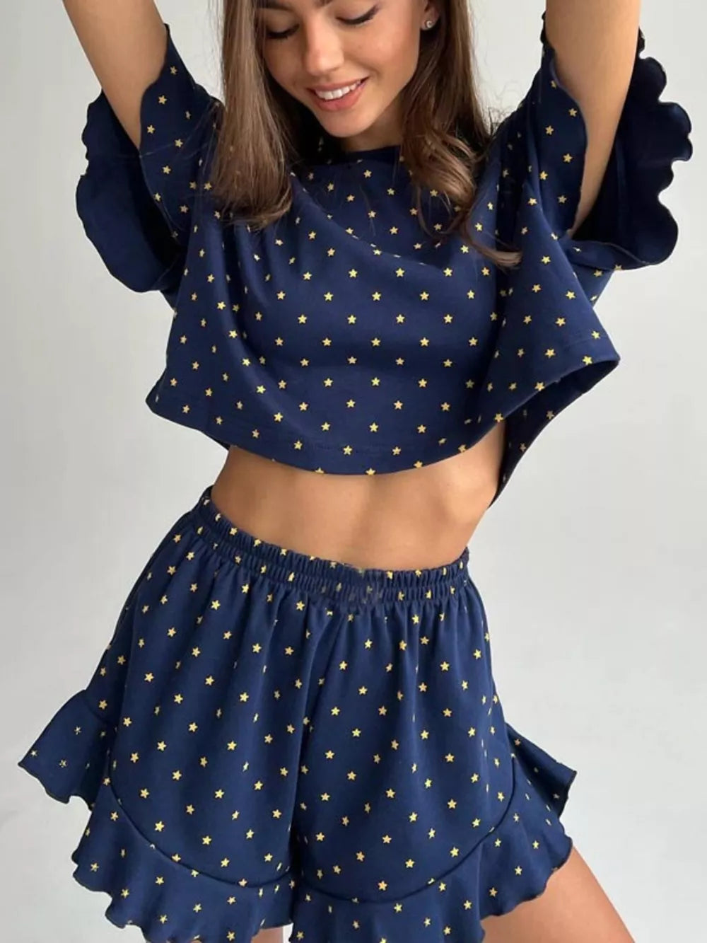 Blue star print crop top and ruffled shorts set made of polyester.