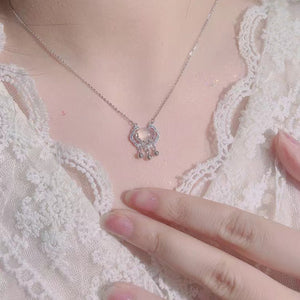 Dainty silver lock pendant necklace with chalcedony and charms.