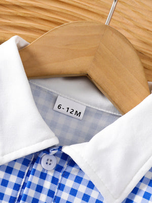 Baby dress with blue gingham pattern, white polo collar, and button detail.