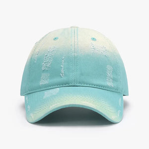 Distressed cotton baseball cap in aqua with a faded yellow ombre and distressed details.