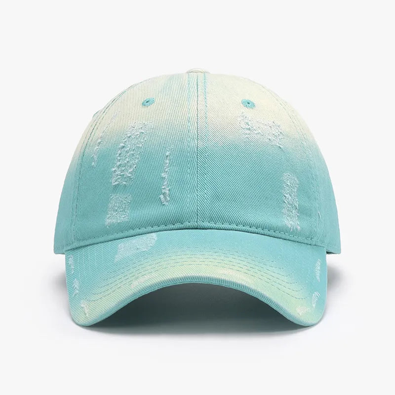 Distressed cotton baseball cap in aqua with a faded yellow ombre and distressed details.