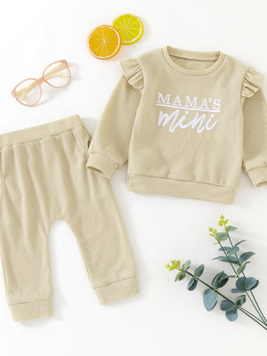 Toddler waffle knit top with ruffled sleeves and "Mama's Mini" graphic, paired with matching pants.