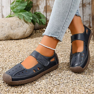 Black round toe platform flats with adjustable strap and cutouts.