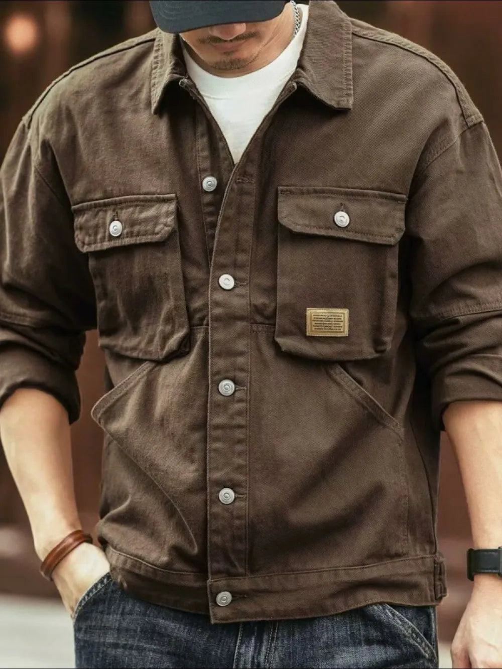 Brown washed cotton chore jacket with utility pockets and button front.