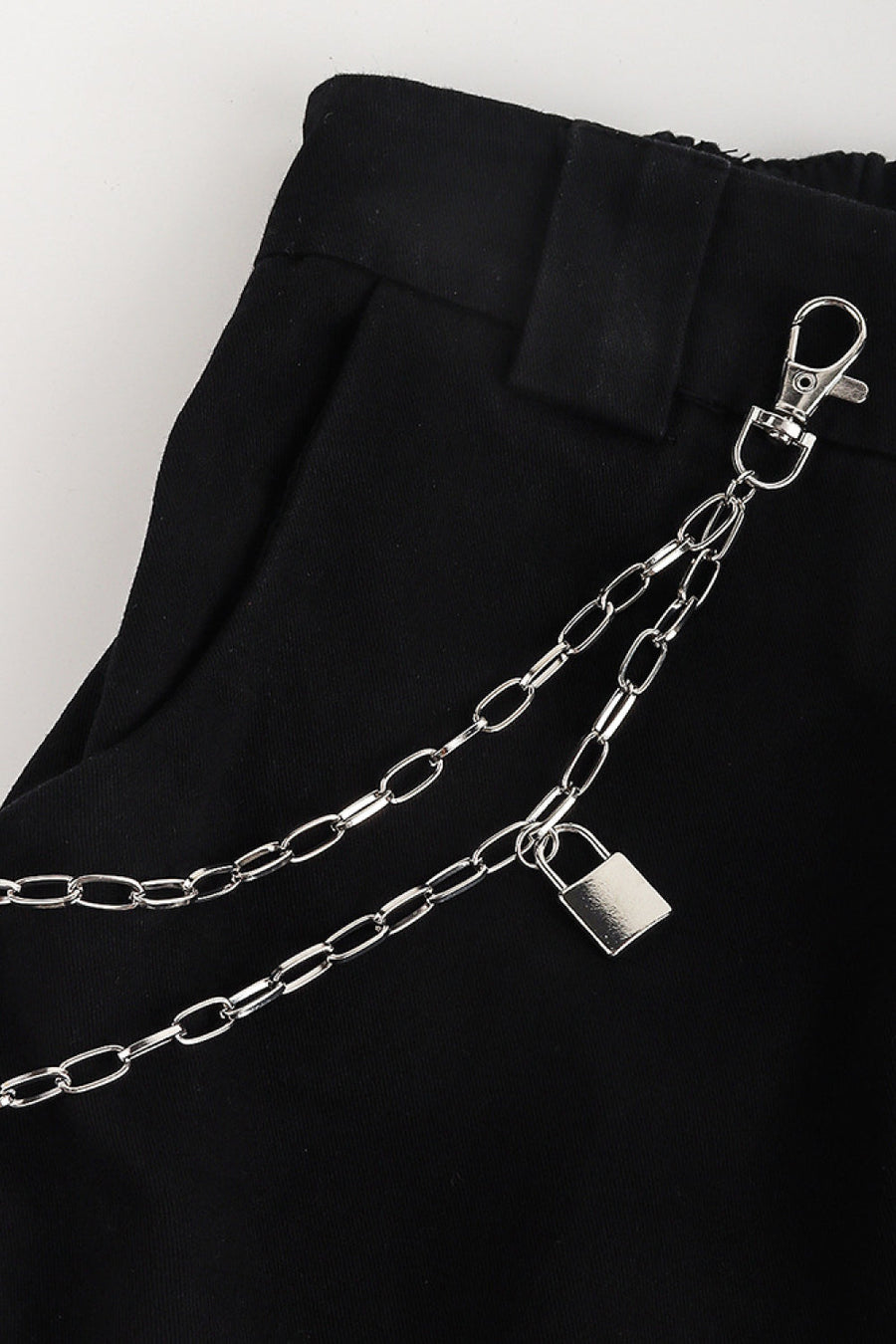 Silver double chain pocket chain with padlock detail on black pants.