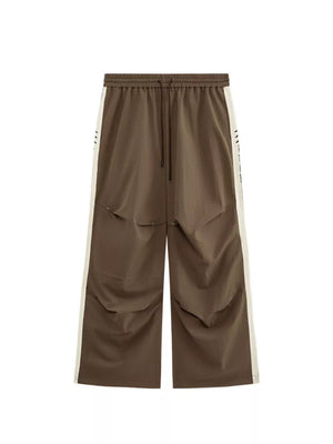 Brown relaxed fit sweatpants with cream side stripe and drawstring waist