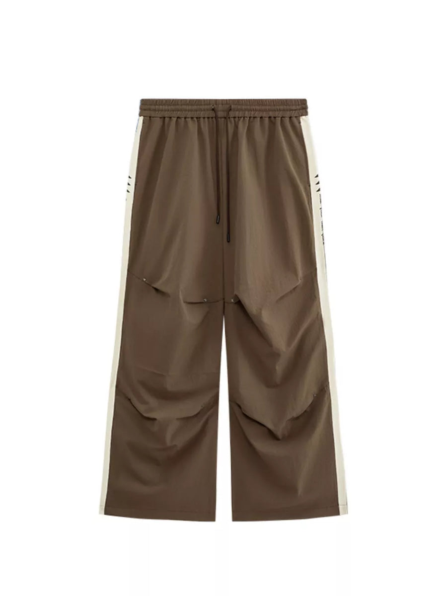 Brown relaxed fit sweatpants with cream side stripe and drawstring waist