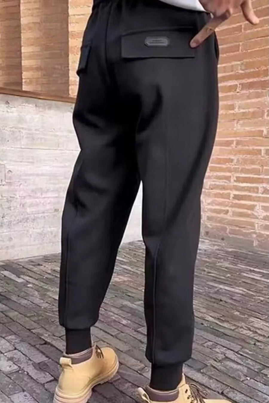 Black cotton sweatpants with drawstring and back pockets.