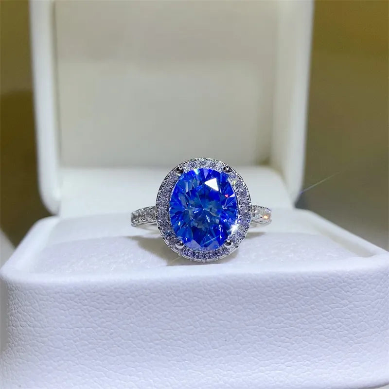 Silver halo ring with oval blue moissanite center stone and diamond accents