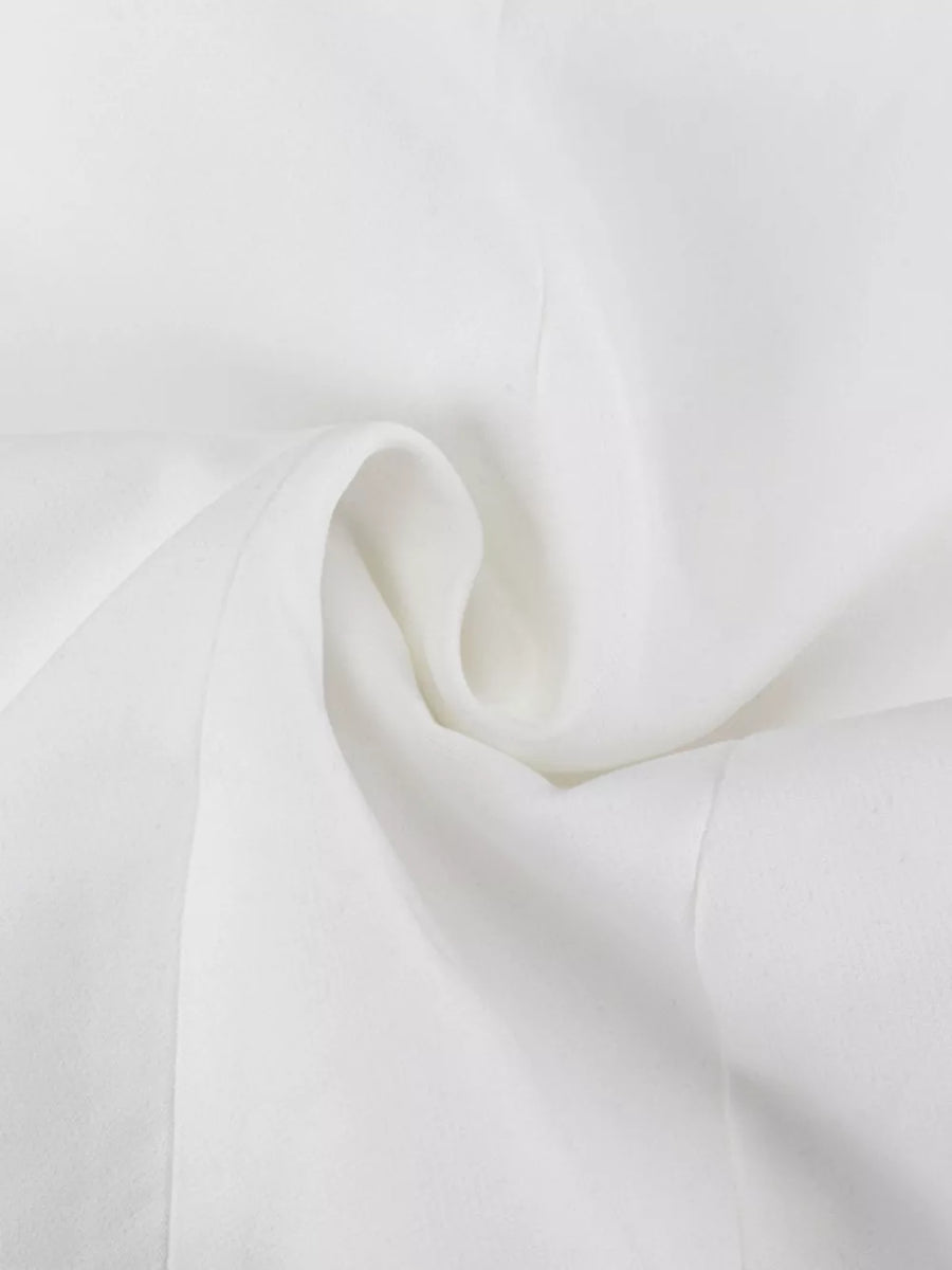 White textured fabric with soft folds and subtle stitching detail.