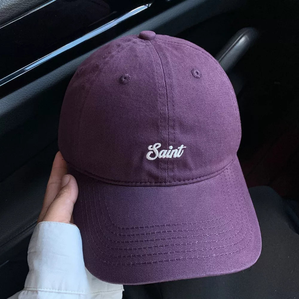 Grape purple cotton baseball cap with white script embroidery and stitched brim.