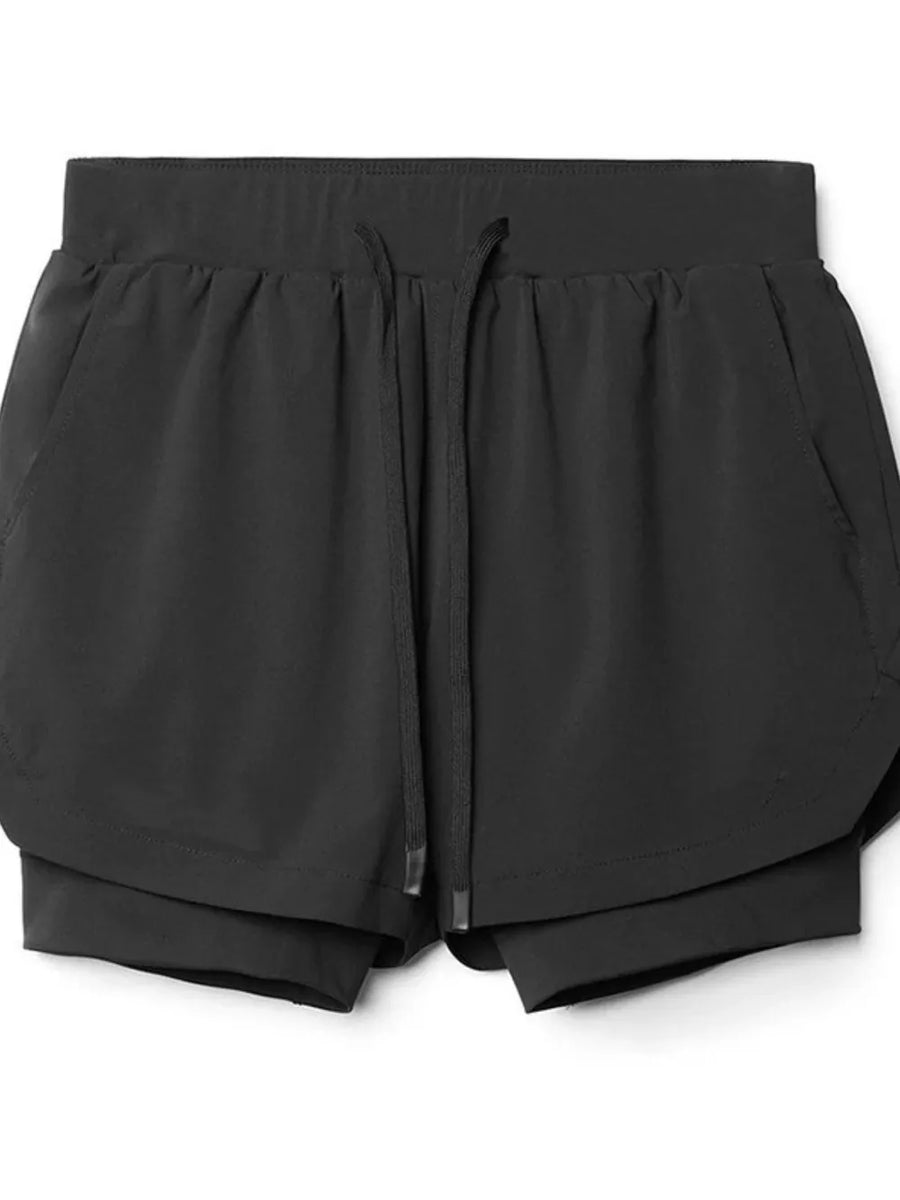 Black layered performance shorts with drawstring and perforated panels.