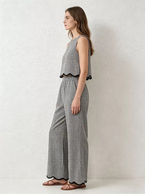 Plaid two-piece outfit set with scalloped trim on crop top and wide-leg pants.