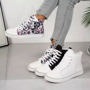 Floral and solid lace-up high-top sneakers in white and black.