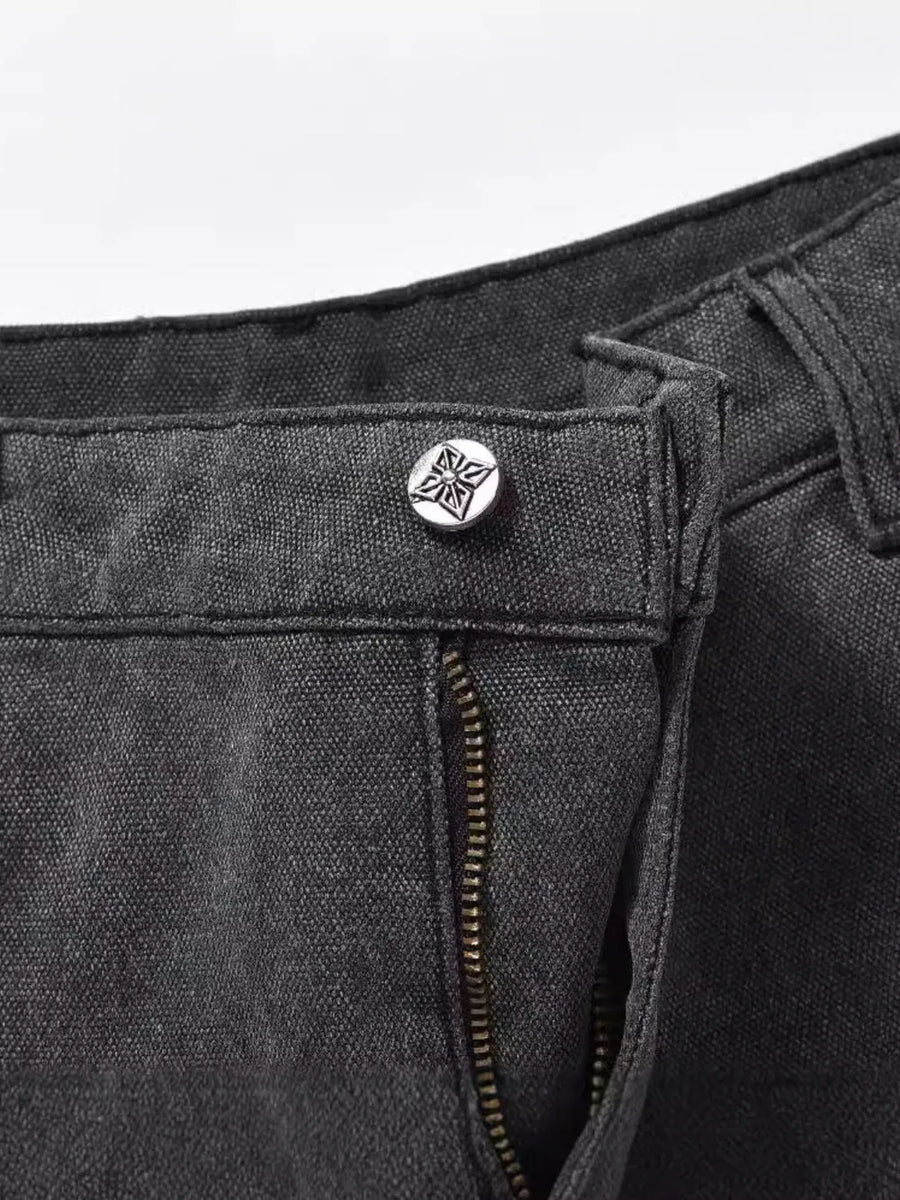 Dark carpenter jeans with embroidered star button detail and zipper.